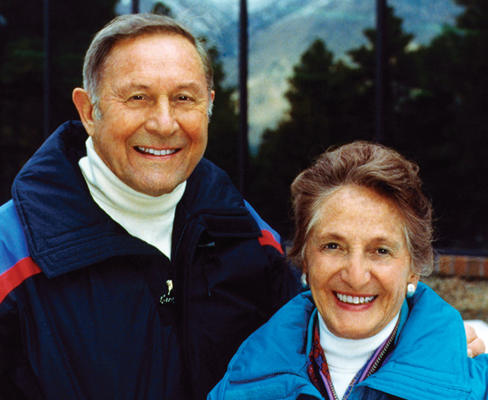 Founders Bill and Vieve Gore posing for a photo in front of a mountain.