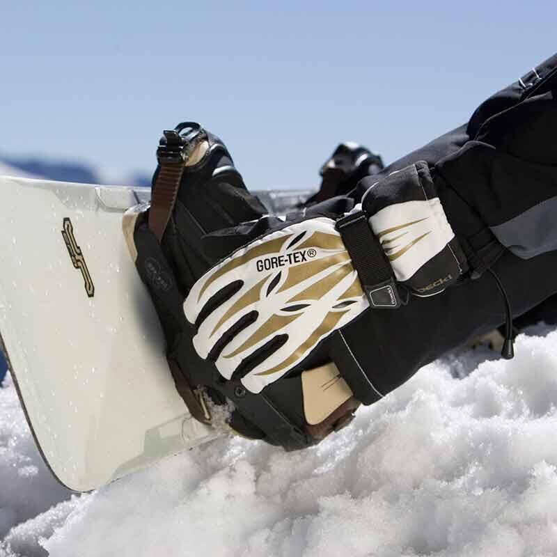 Close up image of snowboard and GORE-TEX gloves